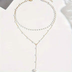 Elegant Vintage Style Double-Layer Pendant Necklace with Imitation Pearl Accents and Tassel Drop